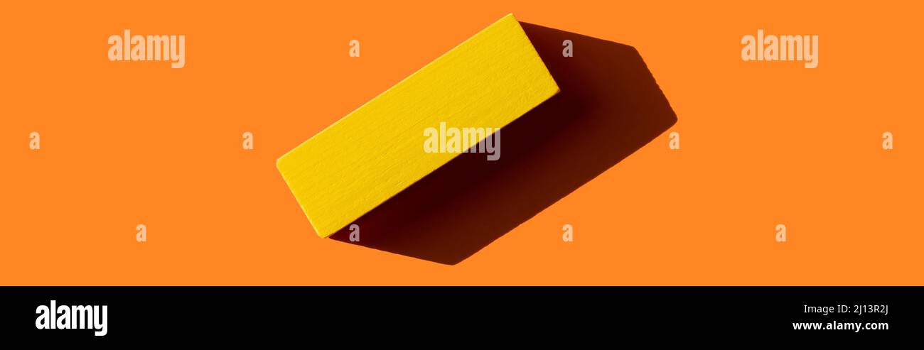 Yellow Rectangular Blocks top view of yellow rectangular block on orange background with shadow ...