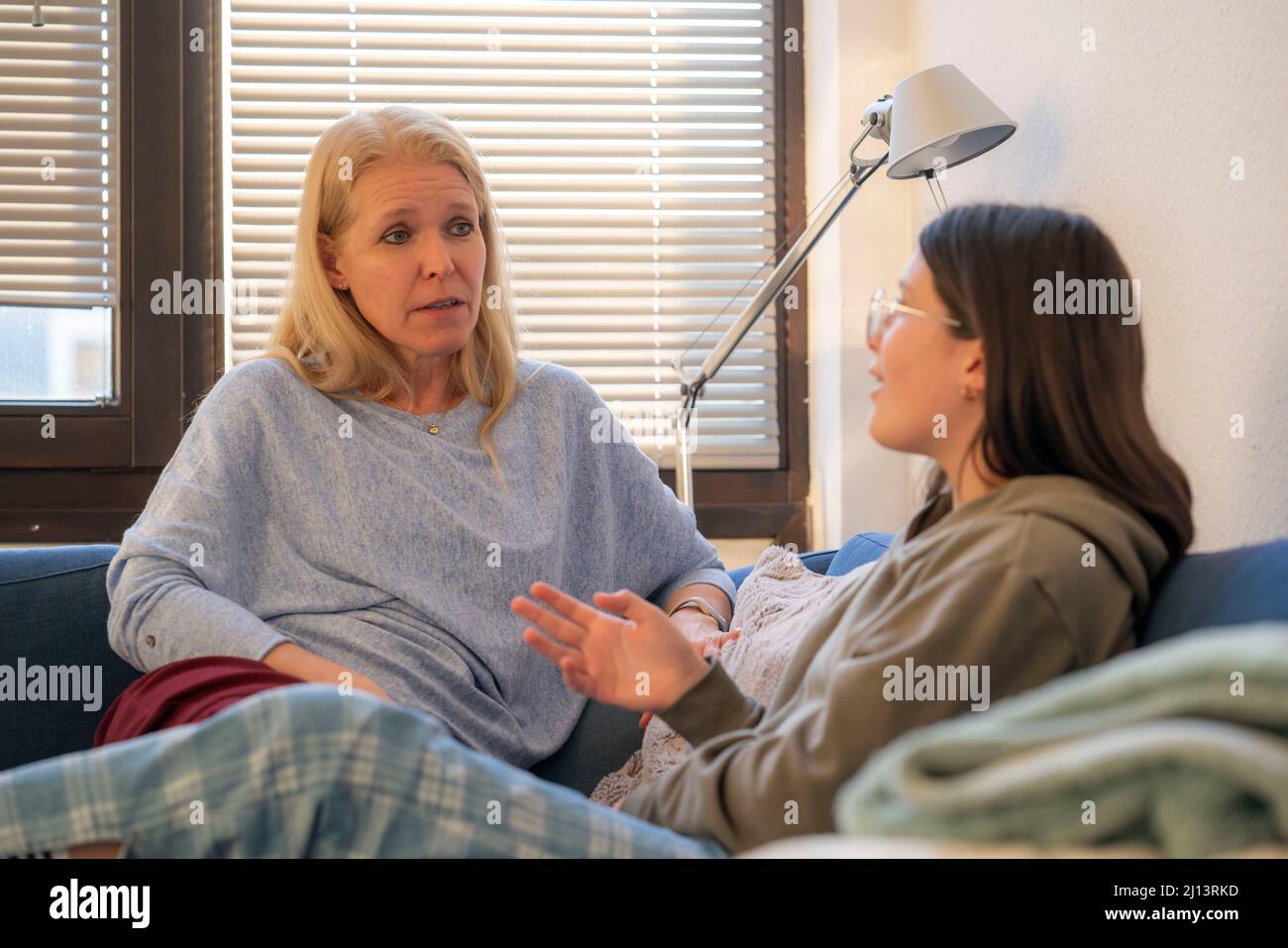Mother and daughter, teenage, 13 years old, in confidential conversation, at home, Stock Photo