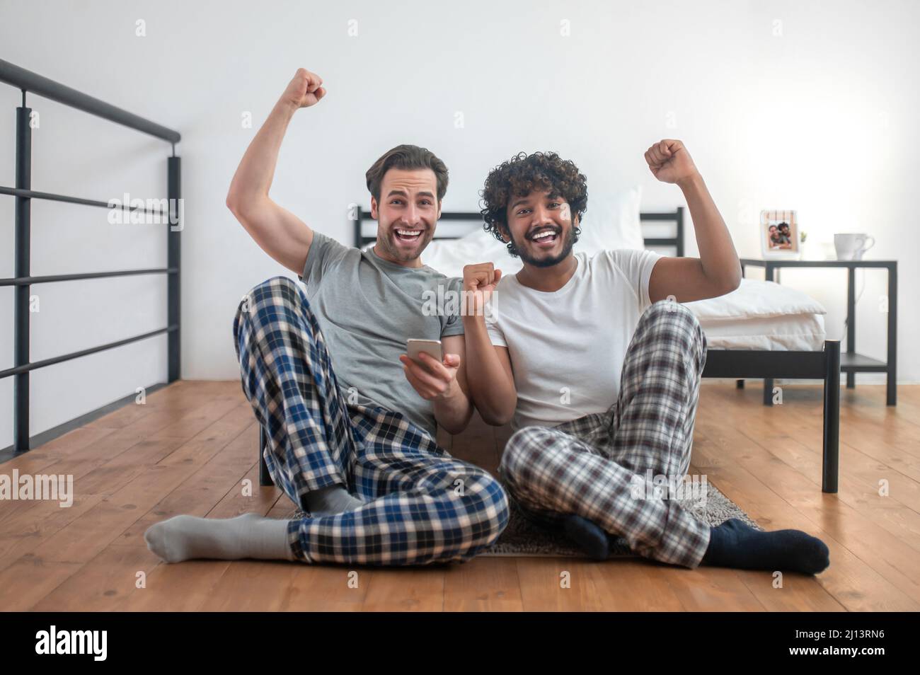 Two cheerful men supporting their favorite sports team Stock Photo