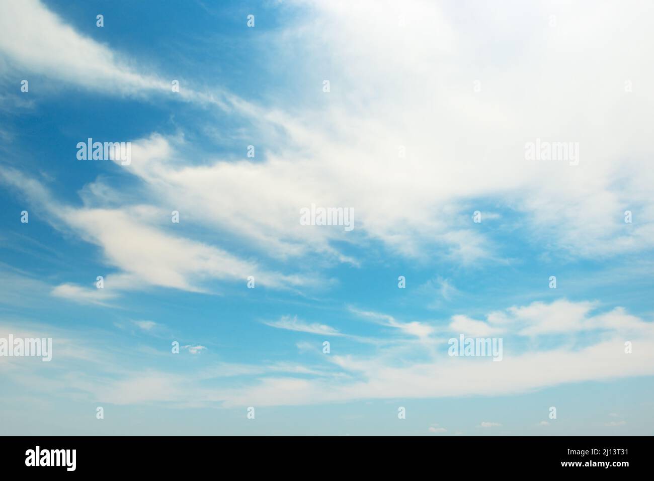 White fluffy clouds on bright blue summer sky Stock Photo - Alamy