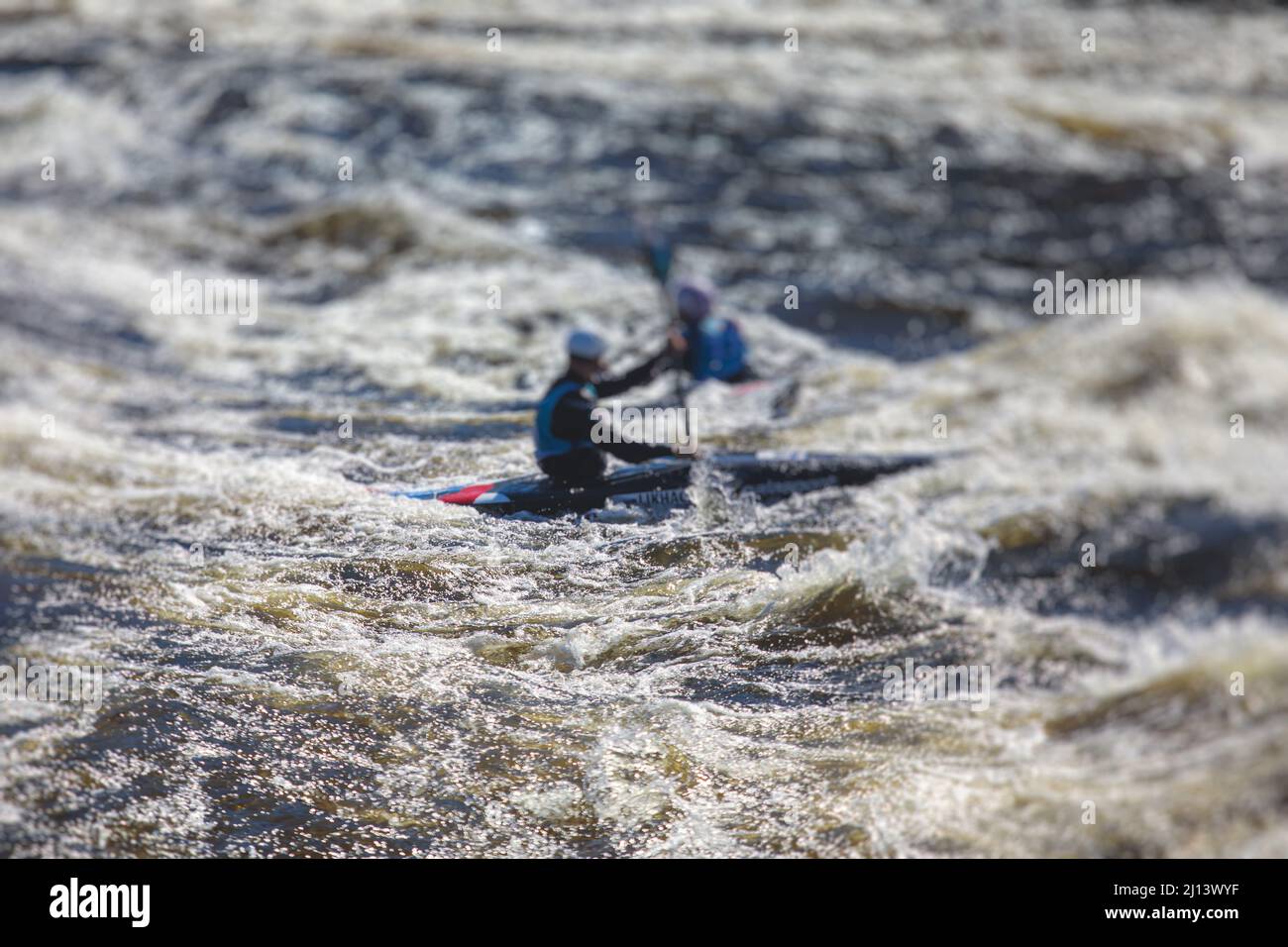 Kayak slalom canoe race in white water rapid river, process of kayaking competition with