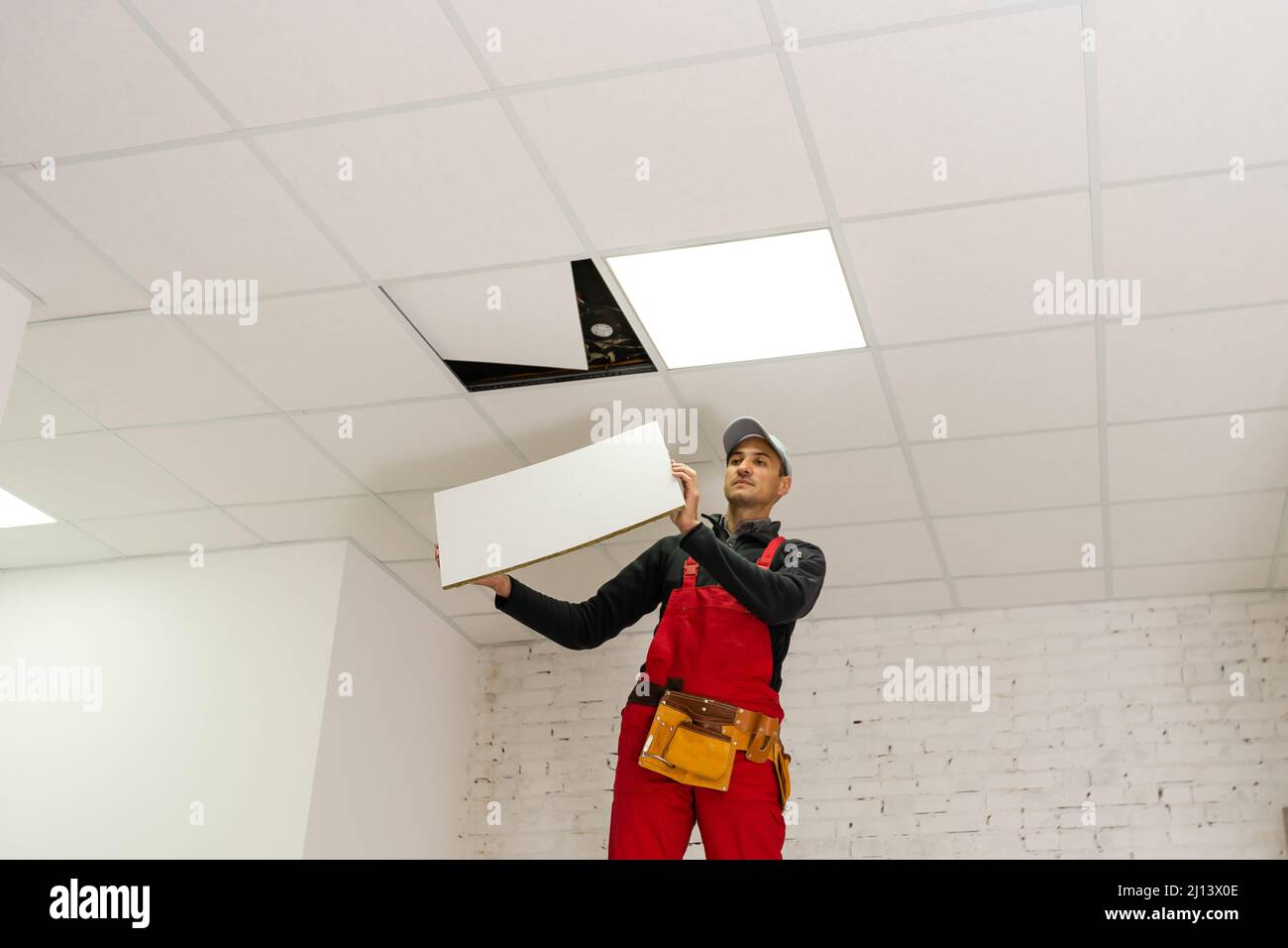 Builder replacing ceiling panel, working, ceiling armstrong Stock Photo ... - Mis Leading Questions For Ceiling Replacements