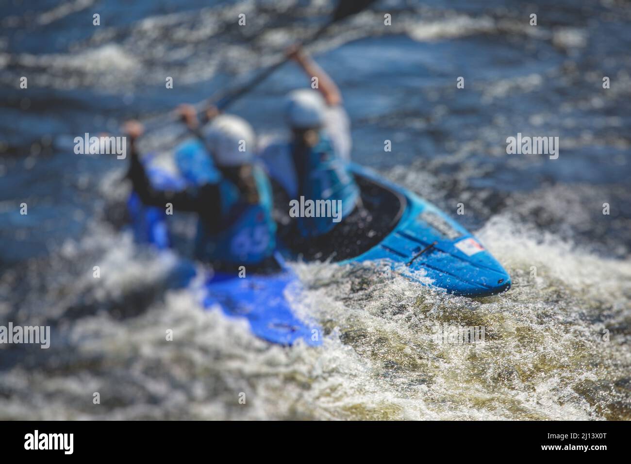 Kayak slalom canoe race in white water rapid river, process of kayaking