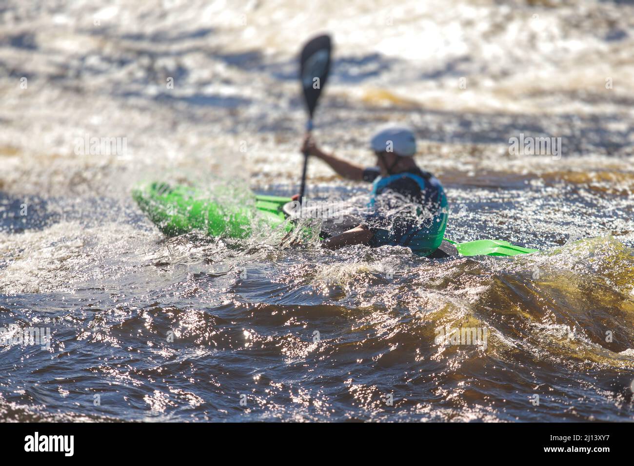 Kayak slalom canoe race in white water rapid river, process of kayaking
