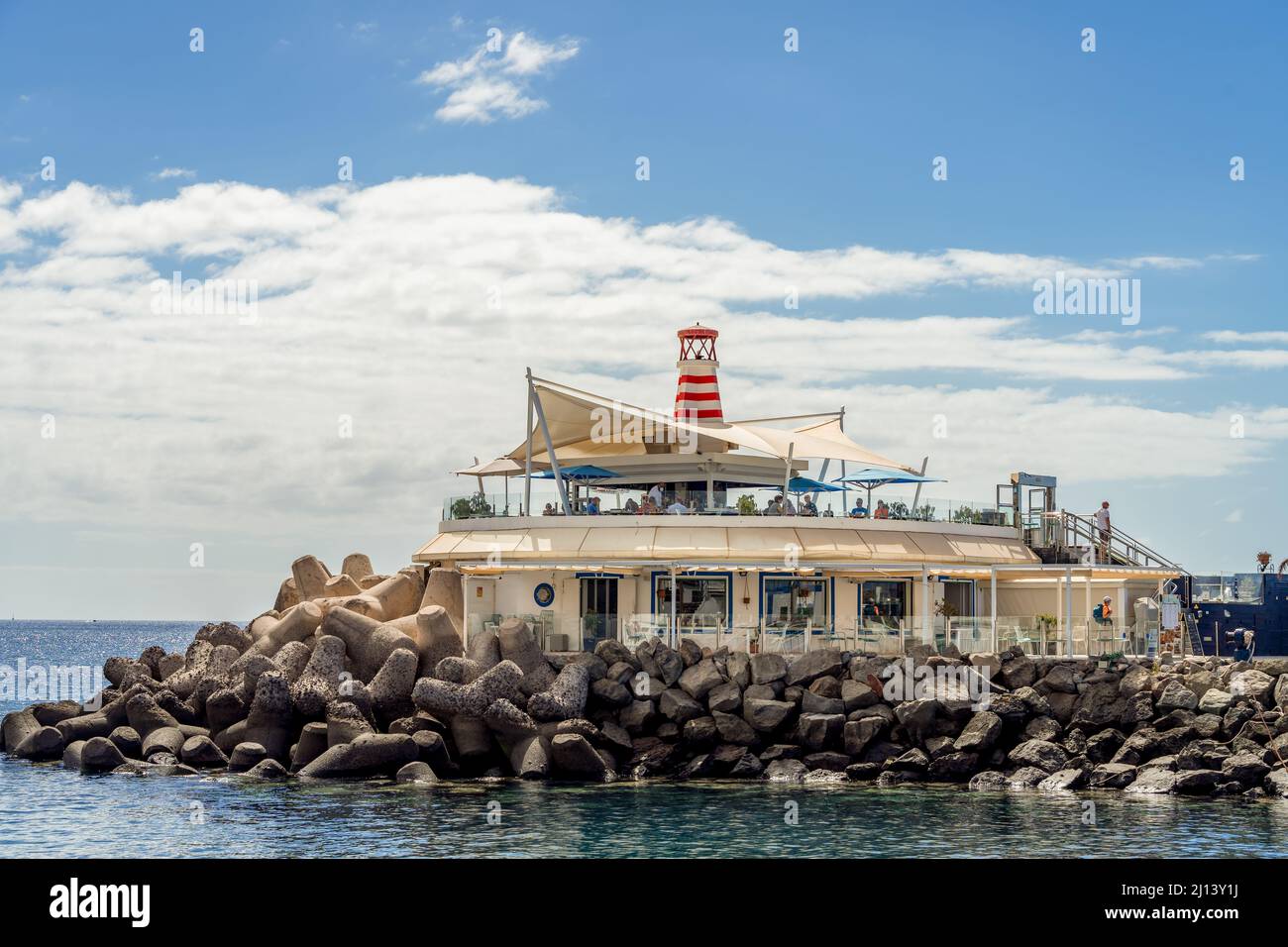 PUERTO DE MOGAN, GRAN CANARIA, CANARY ISLANDS, SPAIN - MARCH 7 : Restaurant in the harbour of Puerto de Mogan Gran Canaria on March 7, 2022. Unidentif Stock Photo