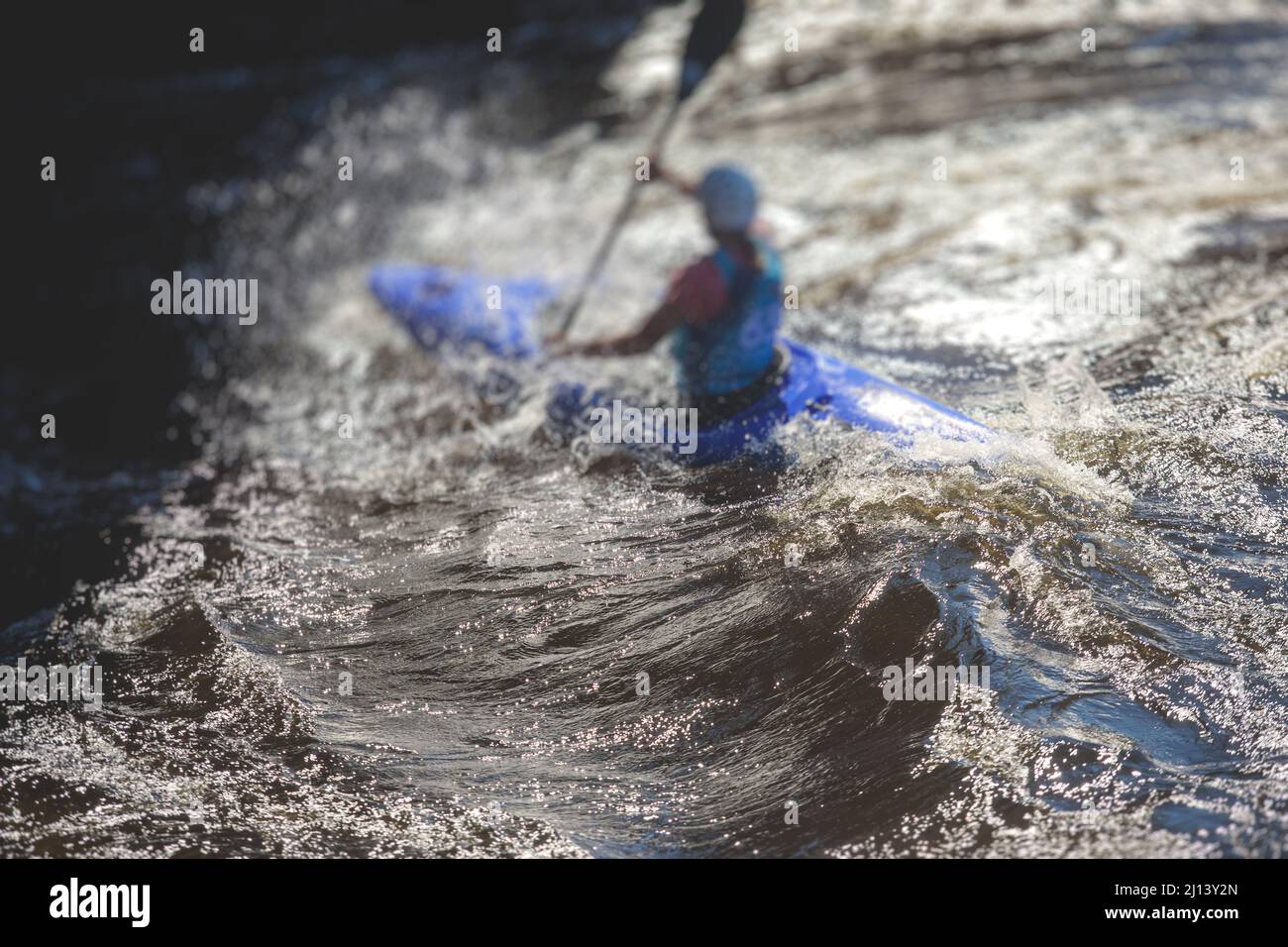 Kayak slalom canoe race in white water rapid river, process of kayaking
