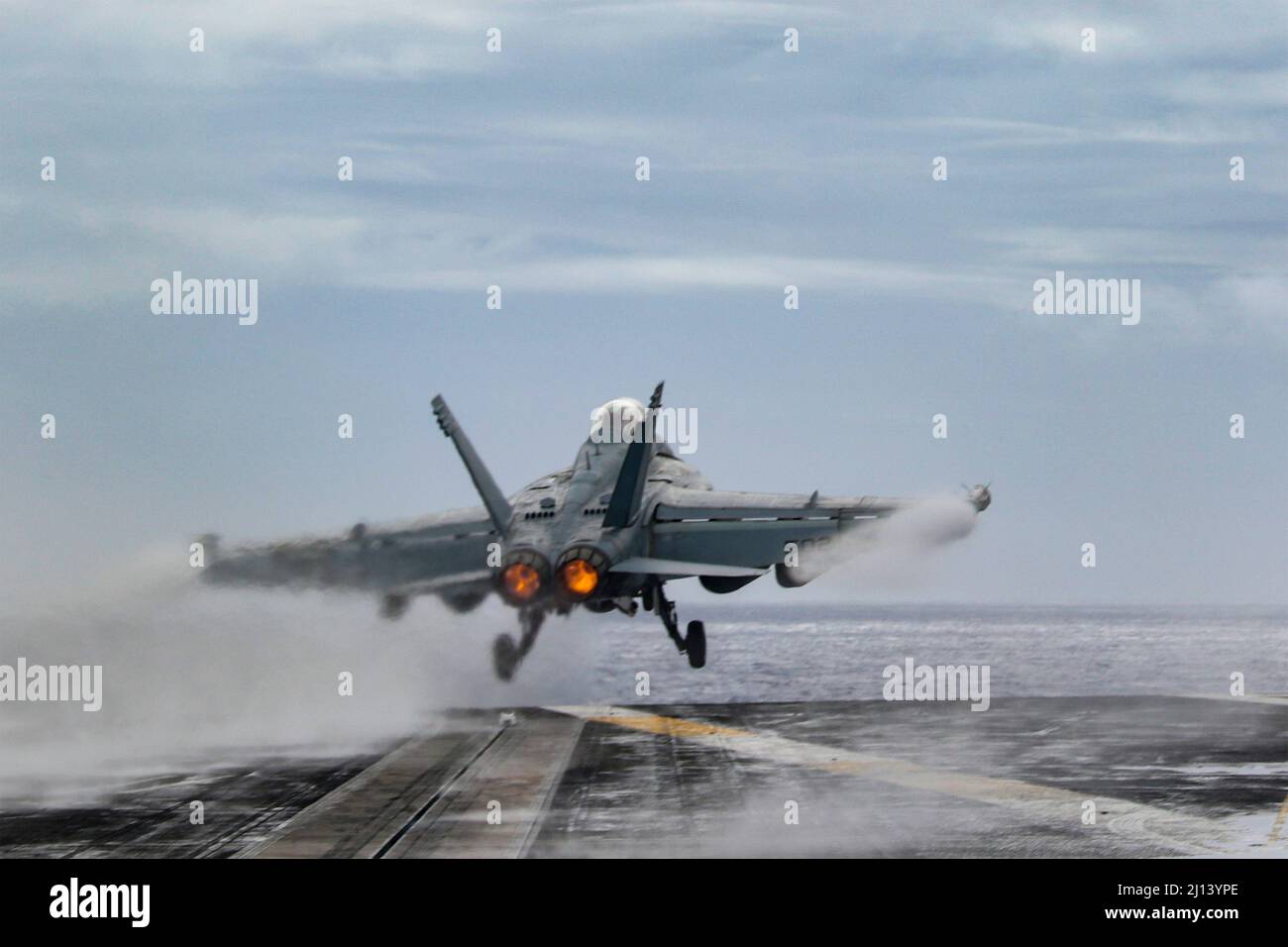 Philippine Sea, United States. 20 March, 2022. A U.S. Navy EA-18G Growler fighter jet, attached to the Wizards of Electronic Attack Squadron 133, launches off the flight deck of the Nimitz-class aircraft carrier USS Abraham Lincoln during routine operations, March 15, 2022 in the Philippine Sea.  Credit: MCS Julia Brockman/Planetpix/Alamy Live News Stock Photo