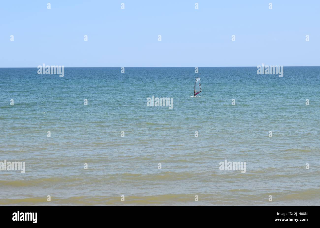 sportsman with wingfoil sailing, in the sea. Windsurfing, Fun in the ocean, Extreme Sport. Azov sea, Russia - July 25.2021 Stock Photo