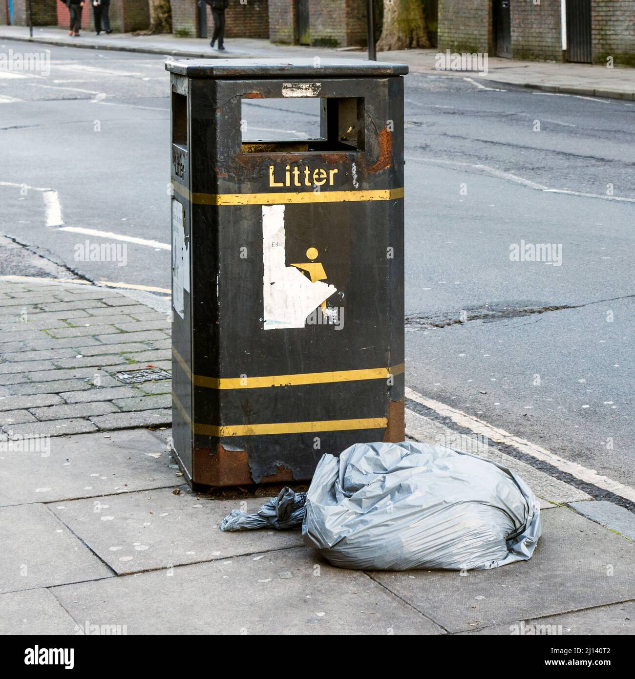 A bag of rubbish left next to a litter bin, London, UK Stock Photo