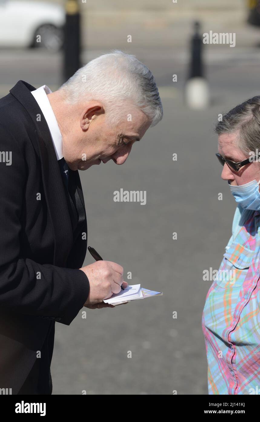Sir Lindsay Hoyle - Speaker of the House of Commons - signing an autograph before the Memorial Service for Dame Vera Lynn at Westminster Abbey, 21st M Stock Photo
