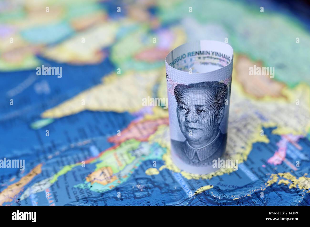 Chinese yuan currency on the map of China. Concept of chinese and asian economy, political conflict over Taiwan Stock Photo