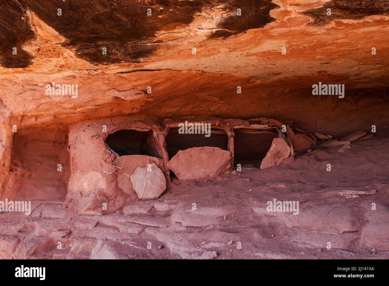 Three ancient Ancestral Pueblan storage granaries in an alcove in the Maze District of Canyonlands National Park in Utah.  These granaries are made of Stock Photo
