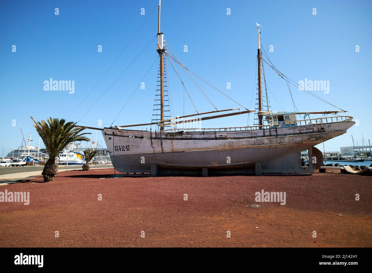 twin mast old wooden canary islands fishing boat m del rosario ashore on hard standing in puerto naos arrecife lanzarote canary islands spain Stock Photo