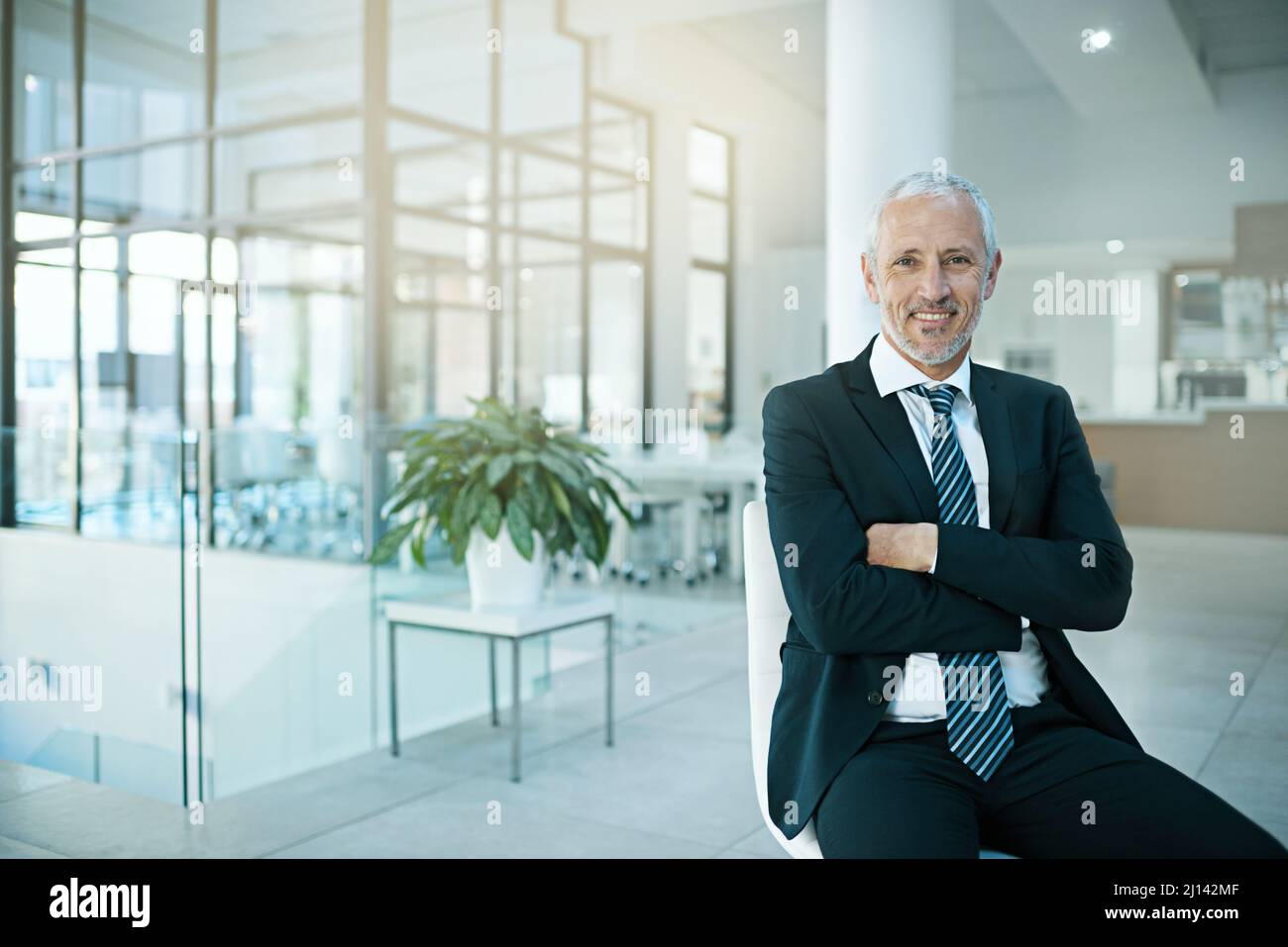 Im committed to excellence. Portrait of a man sitting on a chair in an
