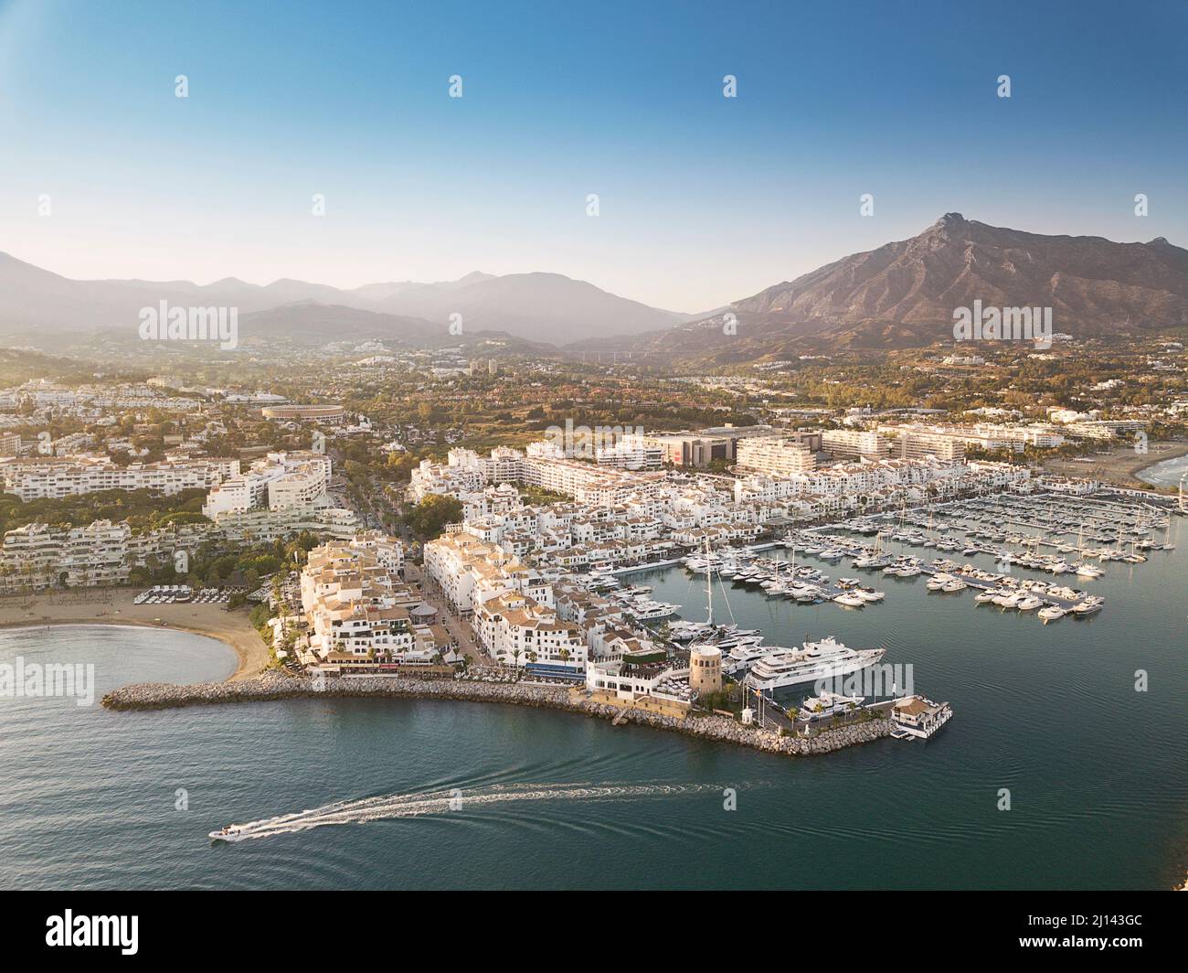 Aerial drone perspective of beautiful sunset over luxury Puerto Banus Bay in Marbella, Costa del Sol. Expensive lifestyle, luxury yachts. Stock Photo