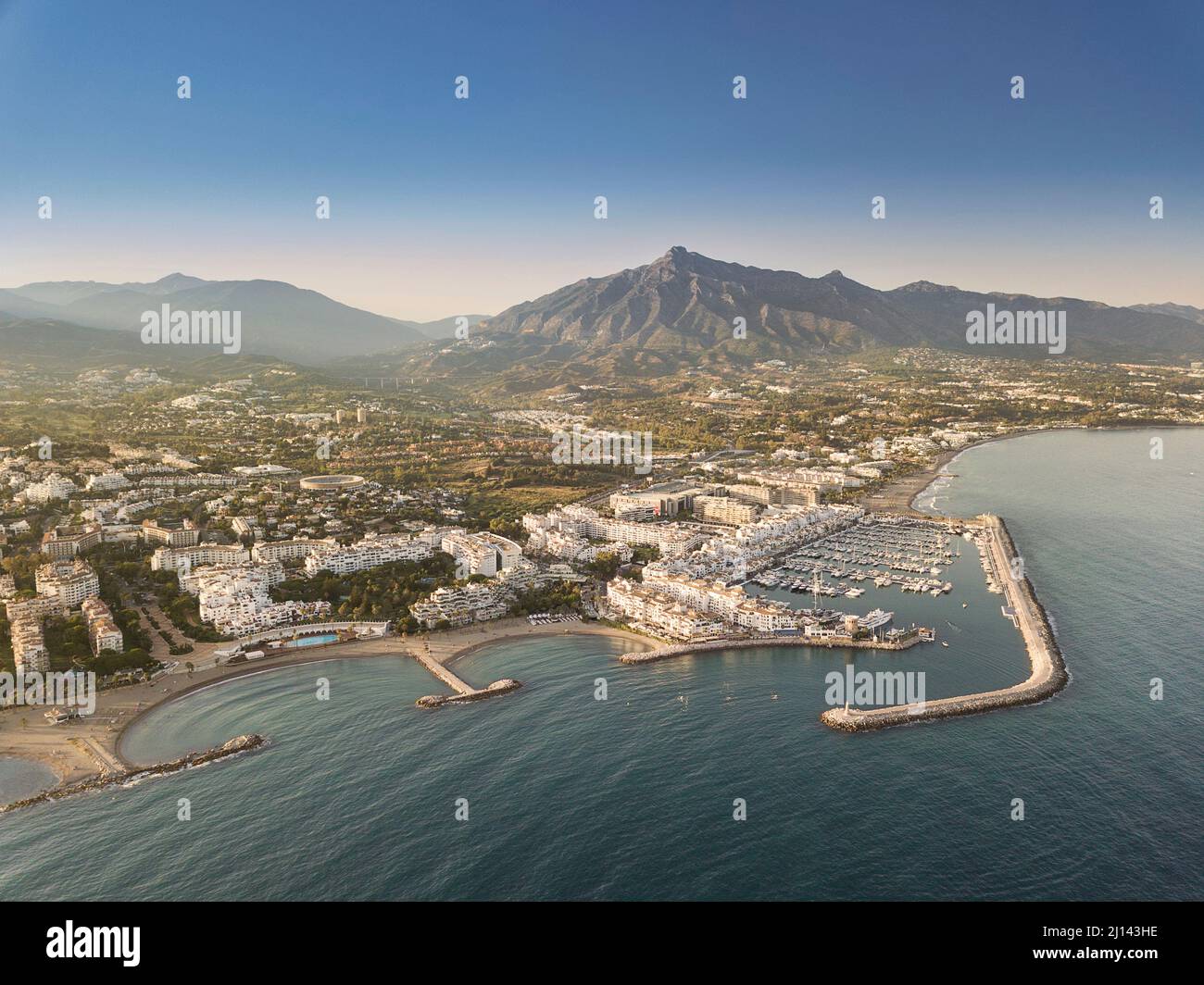Aerial drone perspective of beautiful sunset over luxury Puerto Banus Bay in Marbella, Costa del Sol. Expensive lifestyle, luxury yachts. Stock Photo