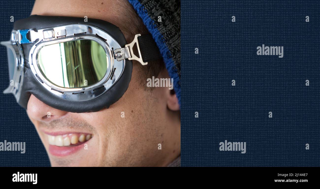 Close up of caucasian man wearing ski goggles against copy space on blue background Stock Photo
