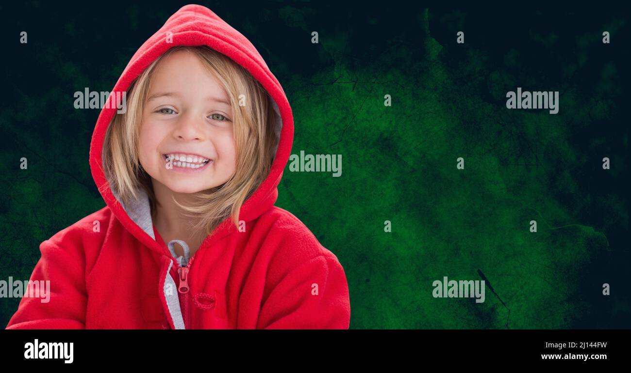 Portrait of caucasian girl smiling against copy space on green grunge textured background Stock Photo