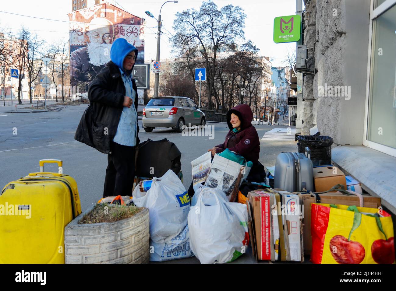 Kyiv, Kyiv, Ukraine. 22nd Mar, 2022. Homeless Irla (L), 35, and her 62 year-old companion are surrounded by belongings on the street, during the newly imposed 35-hour curfew, amid Russian invasion. They say they have nowhere to go to apart from getting into shelters in the event of air raid sirens. (Credit Image: © Daniel Ceng Shou-Yi/ZUMA Press Wire) Stock Photo