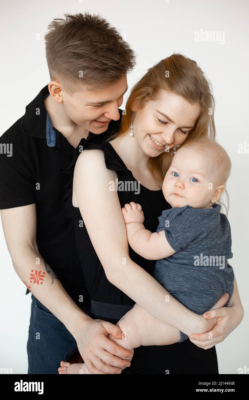 Vertical studio shot of smiling touched happy spouses, parents, family ...