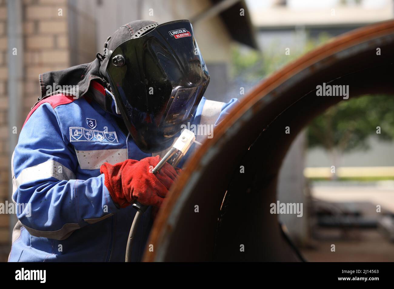Male welder works. Welding joint of large diameter pipe. High pressure