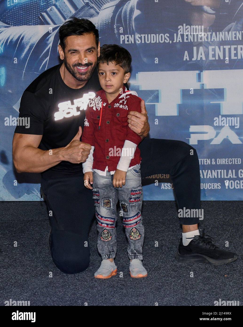 Bollywood actor John Abraham with a kid attend the trailer launch ...