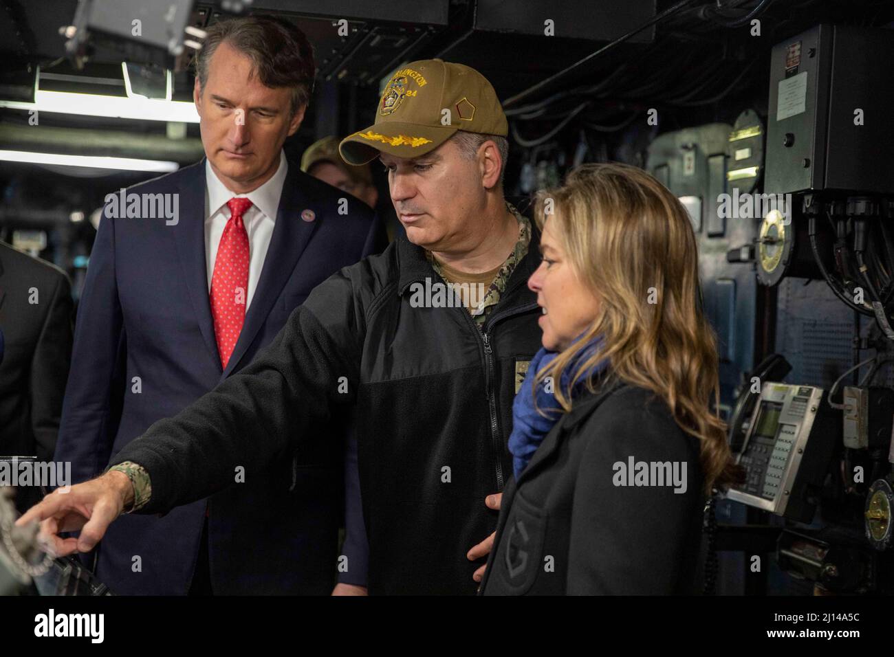 Norfork, United States. 20 March, 2022. U.S. Navy Capt. Eric Kellum, commanding officer of USS Arlington, center, shows Virginia Governor Glenn Youngkin, left, and wife, Suzanne Youngkin, the instruments in the pilot house of the San Antonio-class amphibious transport dock ship, March 20, 2022 Norfork, Virginia. Youngkin came to speak to the sailors and marines before their deployment with the Kearsarge Amphibious Ready Group.  Credit: MCS Keith Nowak/US Navy/Alamy Live News Stock Photo