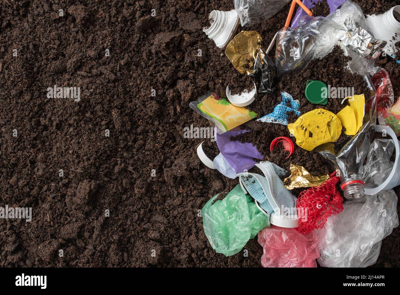 Plastic waste and black soil with a copy space Stock Photo Alamy