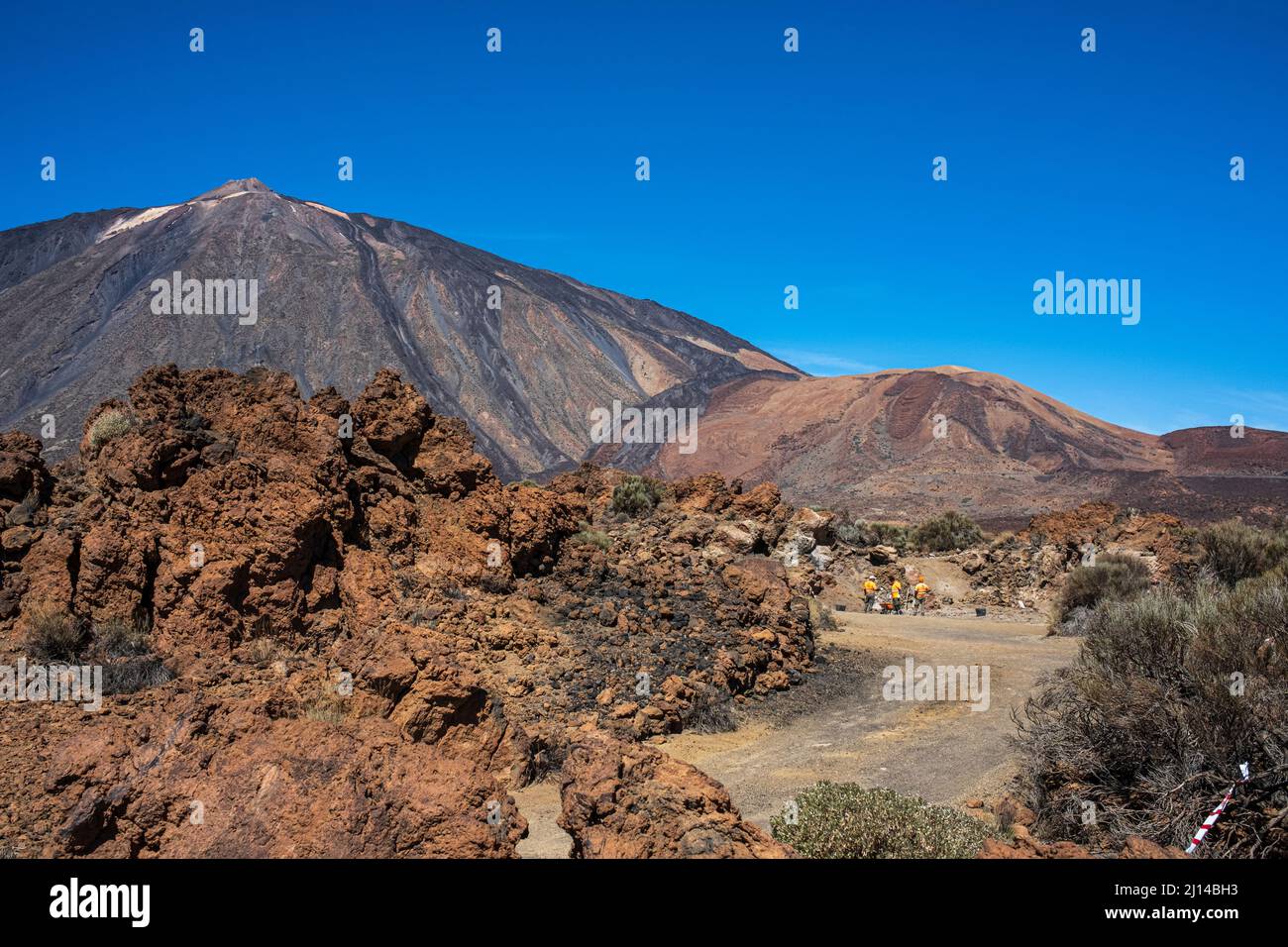 Workmen in orange hi viz at the old sanatorium site to remove all traces of the buildings from the Las Canadas del Teide national park, Tenerife, Cana Stock Photo