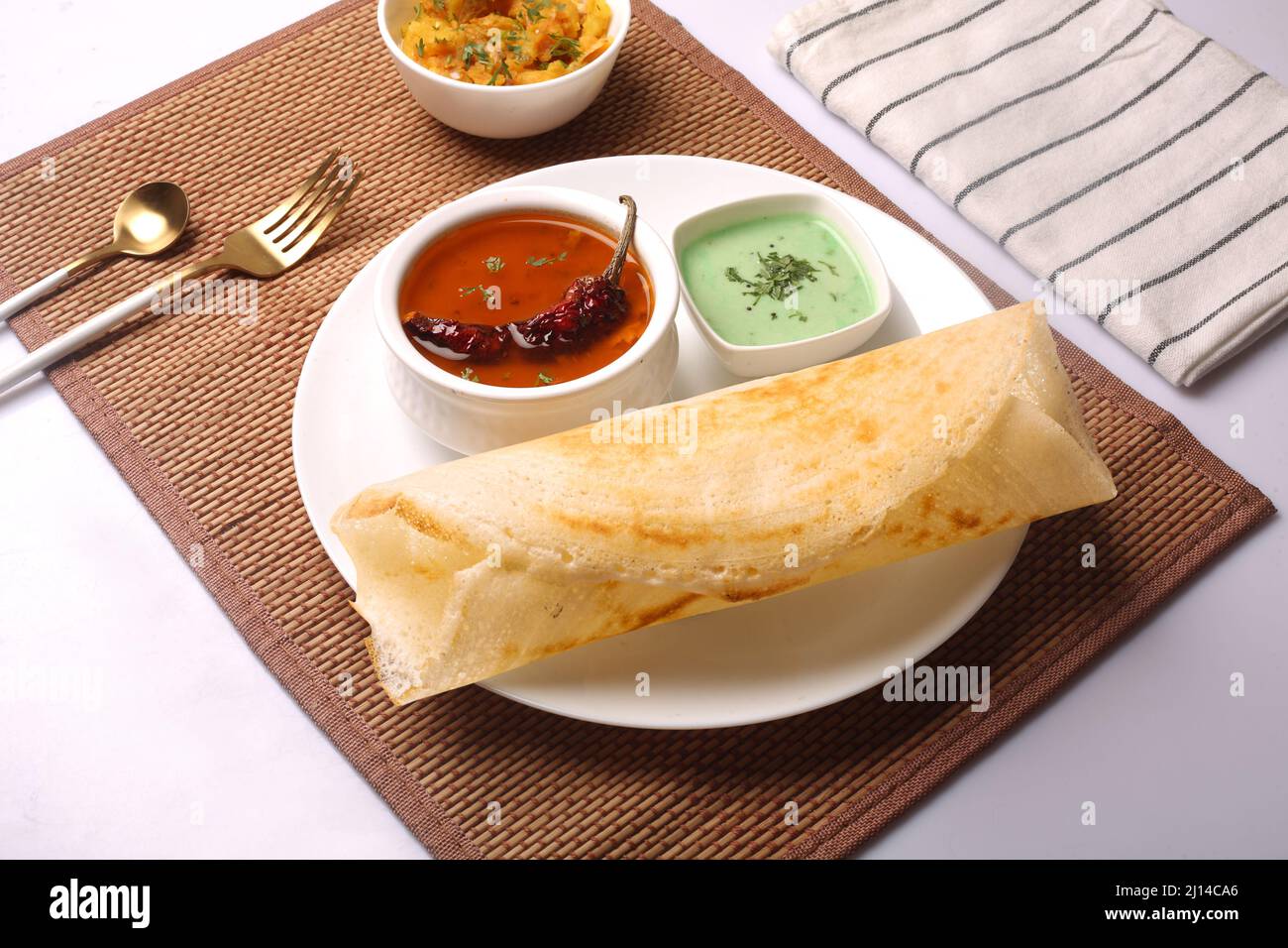 Closeup of a Masala dosa Indian dish, Thick green pea soup dish and a