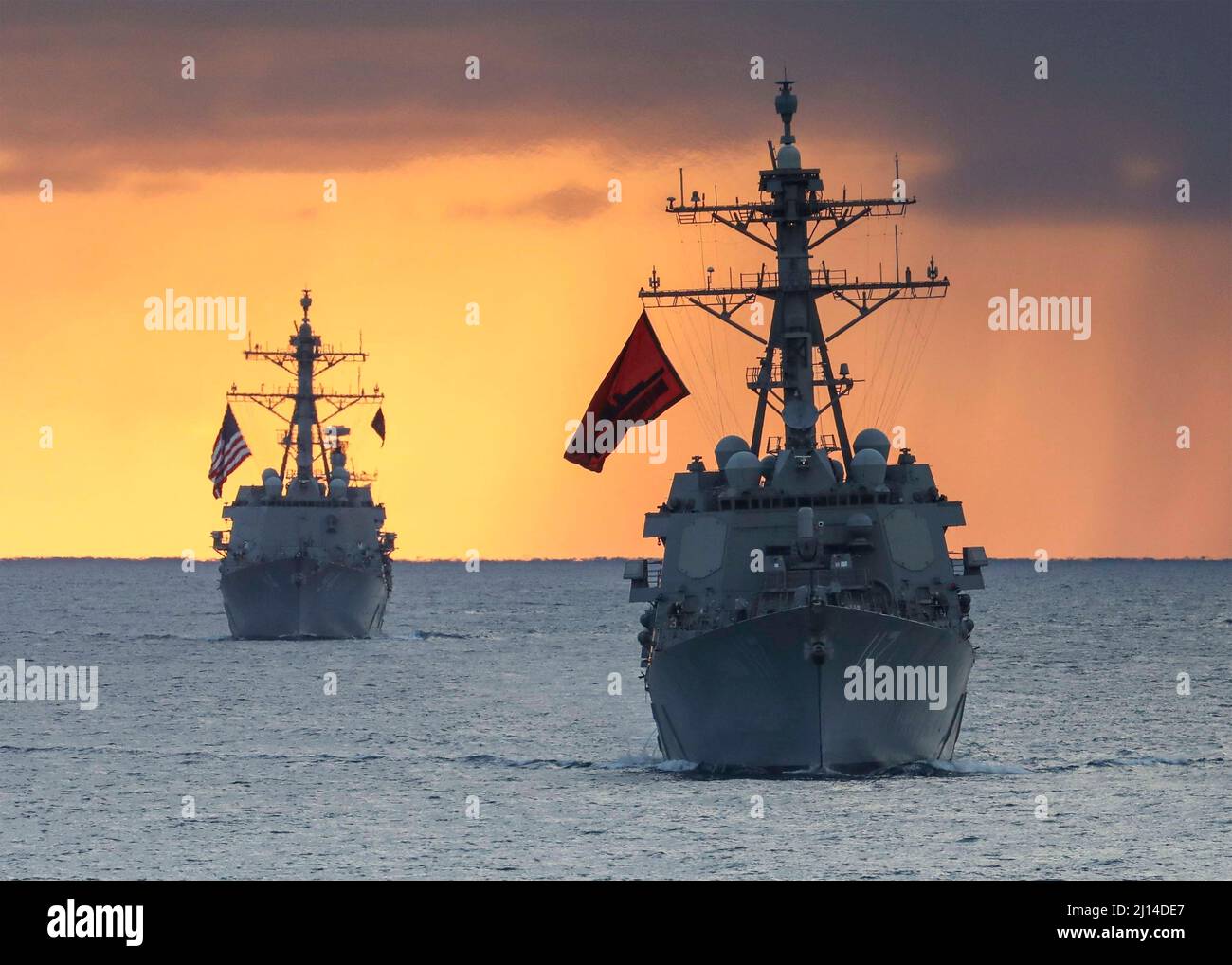 Atlantic Ocean, United States. 15 March, 2022. The U.S. Navy Arleigh-burke class guided-missile destroyers USS Paul Ignatius, right, and the USS Nitze sail in formation at sunset, March 15, 2022 in the Atlantic Ocean.  Credit: MC1 Eric Coffer/Planetpix/Alamy Live News Stock Photo