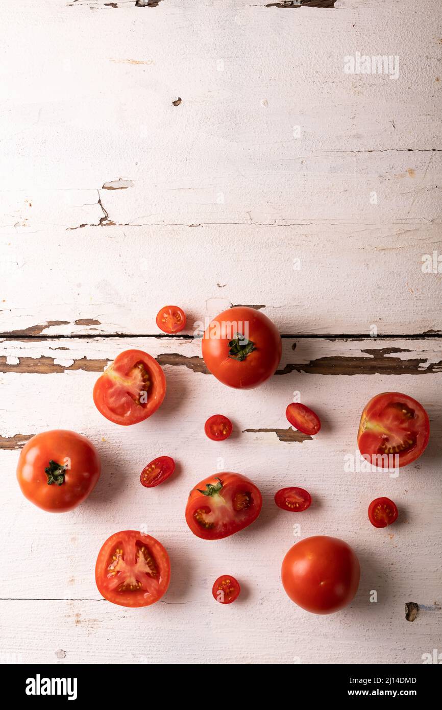 Directly view of fresh tomato variations on white wooden table Stock Photo