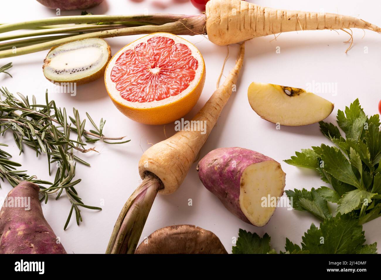 High angle close-up view of fresh vegetables and fruits on white background Stock Photo
