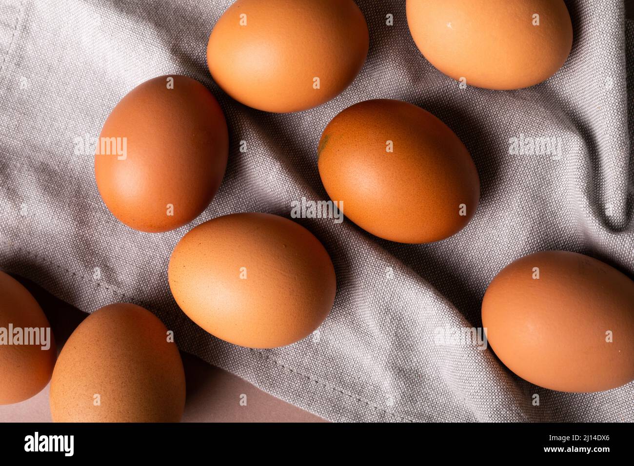 Directly above view of fresh brown eggs on gray napkin Stock Photo