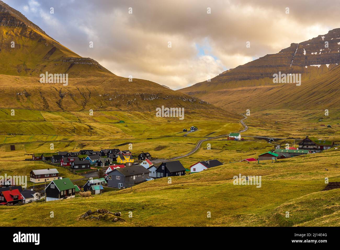 Small village Gjogv situated on the slope of the mountain on Eysturoy ...