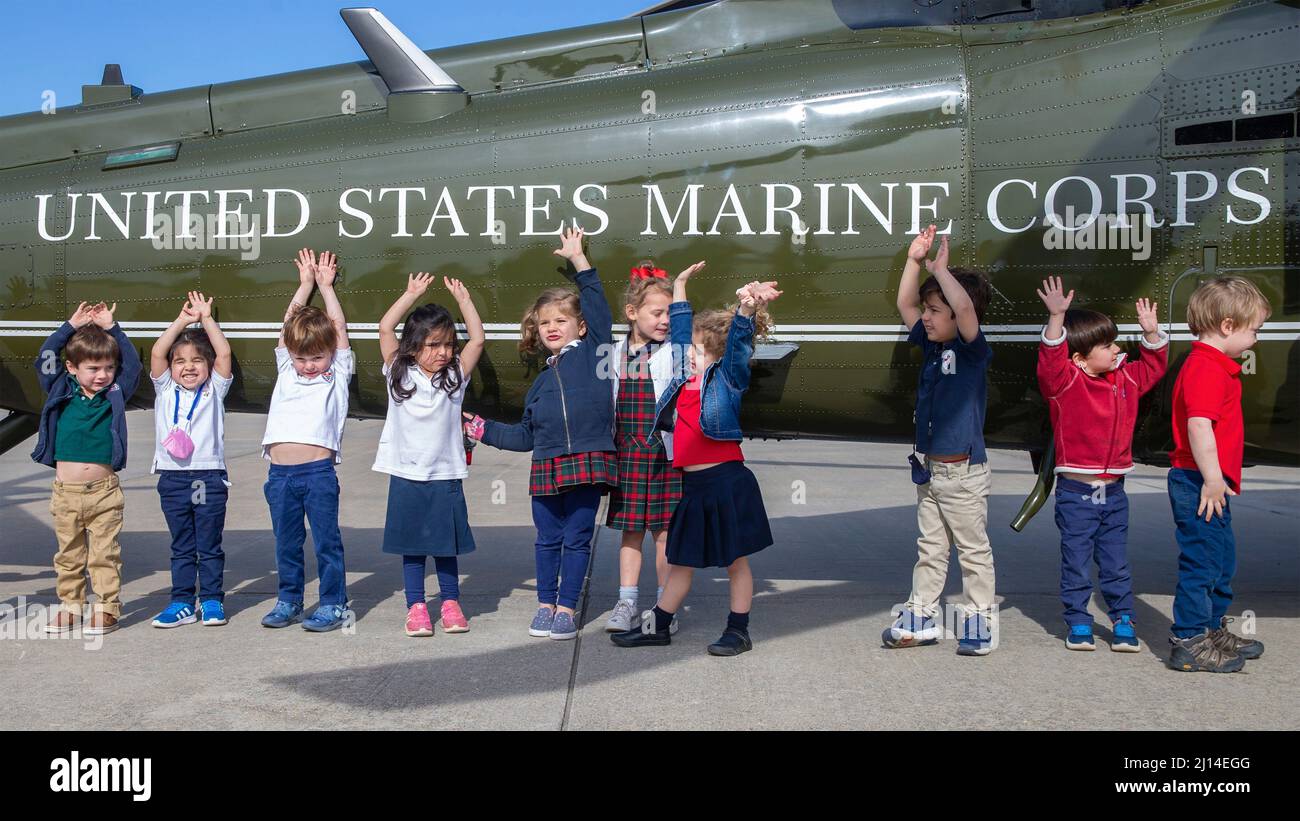 Quantico, United States. 16 March, 2022. Pre-school students from St. Stephens and St. Agnes School Pre-K class raise their hands in front of a helicopter during a visit to the Marine Corps Air Facility Quantico, March 16, 2022 in Quantico, Virginia.  Credit: LCpl. Kayla LaMar/U.S. Marines/Alamy Live News Stock Photo