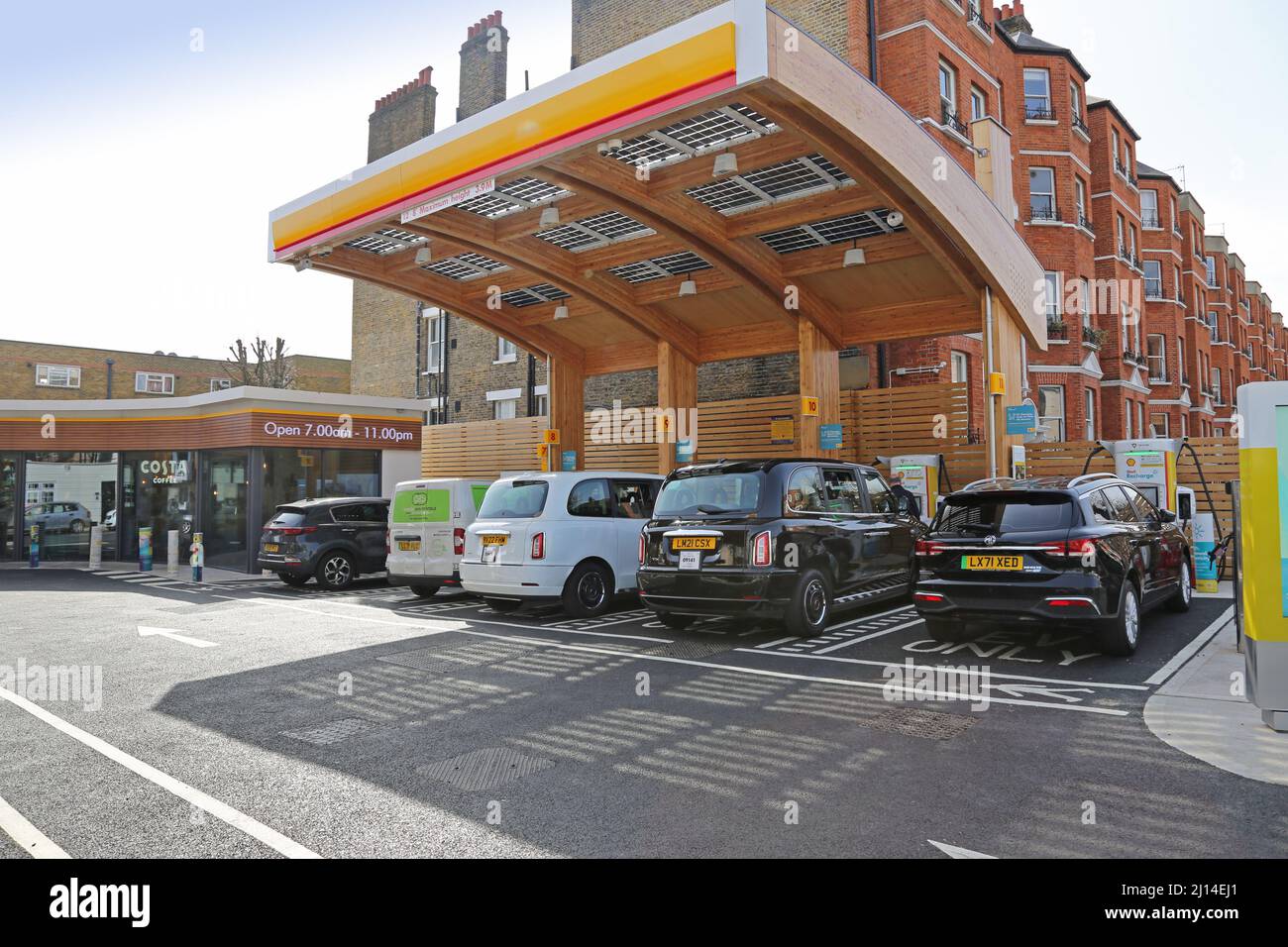 Oil company Shell's new Recharge Station on Fulham Road, west London, UK. The busy garage forecourt provides only electric charging. Stock Photo