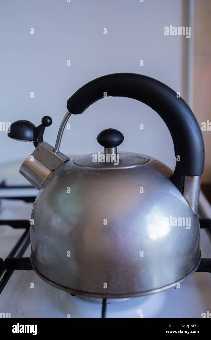 a whistling metal kettle on the stove Stock Photo Alamy