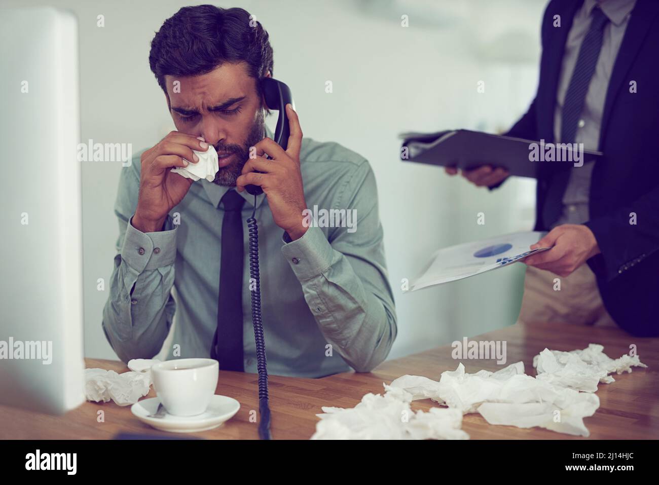 He could do with a time-out from work. Cropped shot of a businessman suffering with allergies in an office. Stock Photo