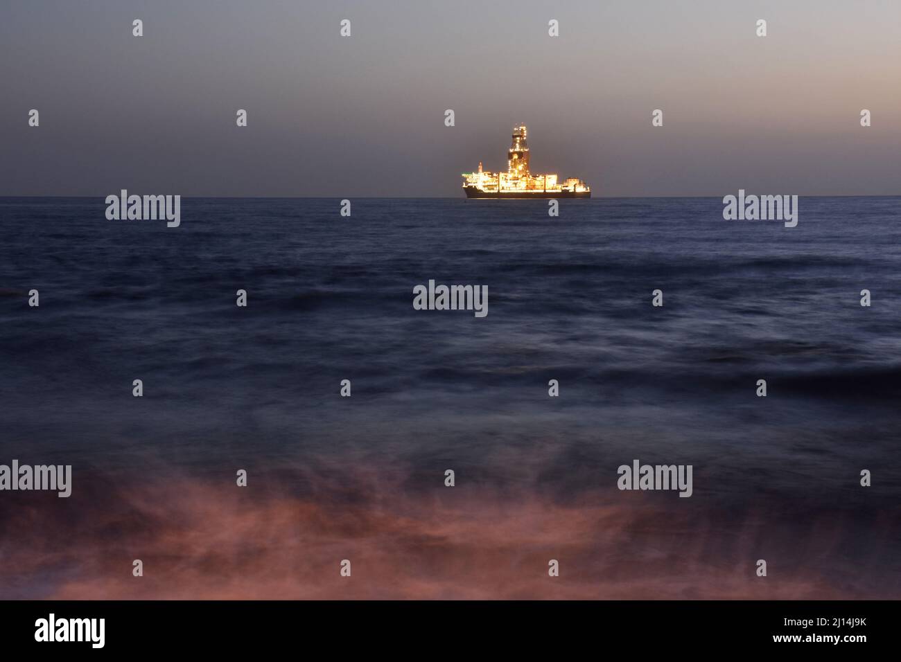 Drillship off the coast of Las Palmas illuminated at dawn, Gran Canaria Canary Islands Spain. Stock Photo