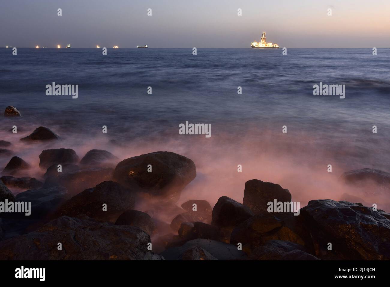 Drillship off the coast of Las Palmas illuminated at dawn, Gran Canaria Canary Islands Spain. Stock Photo