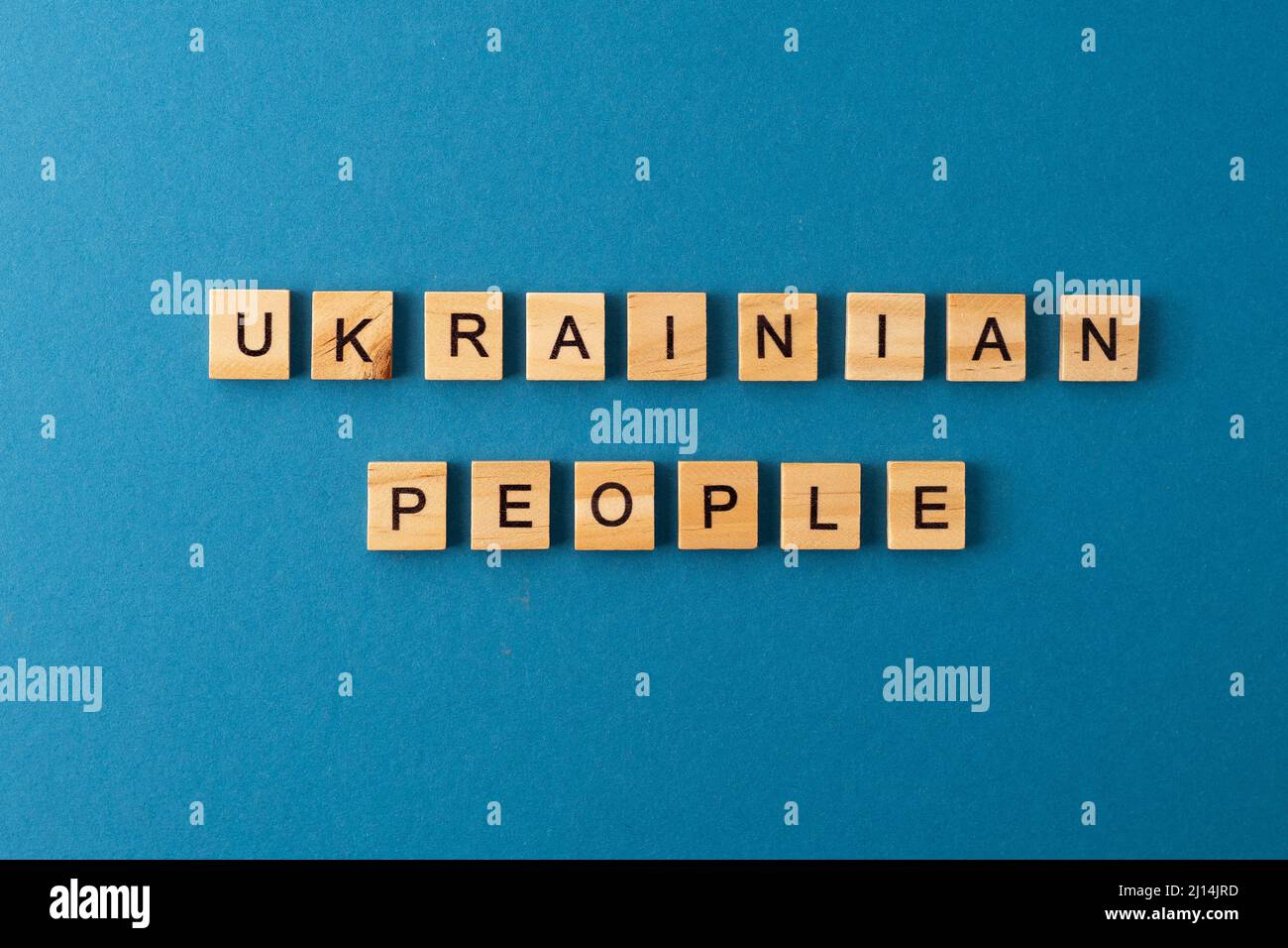 Ukrainian people background. Phrase from wooden letters. Top view words. The phrases is laid out in wood letter. Motivation. Stock Photo