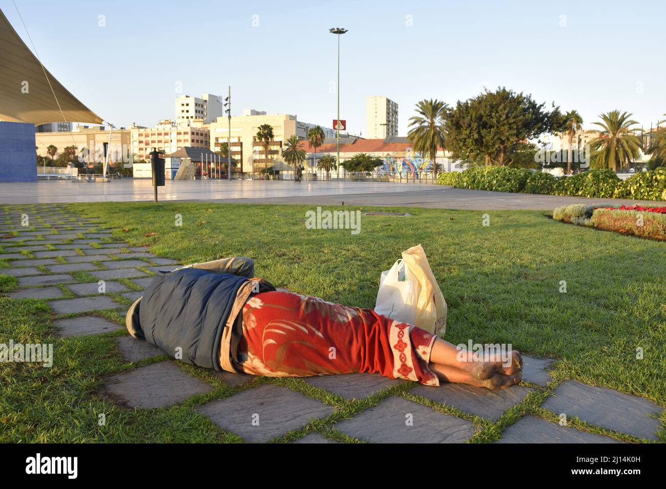 Homeless man sleeping on the ground in Las Palmas Gran Canaria Spain. Stock Photo