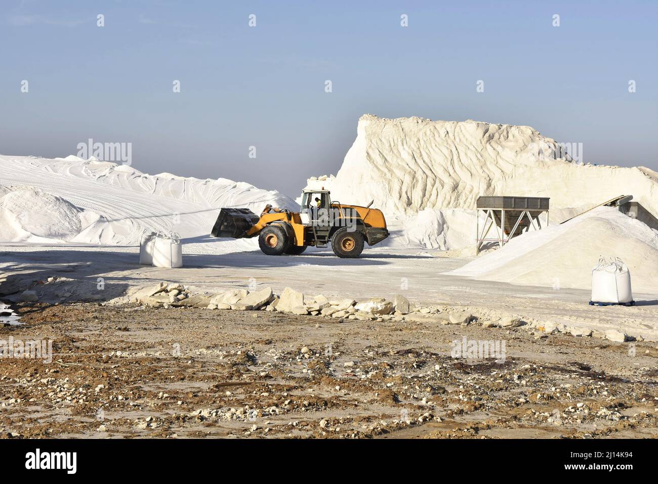 Salt production site, salt is being heaped up after harvesting from the saline ponds, Huelva Spain Europe. Stock Photo