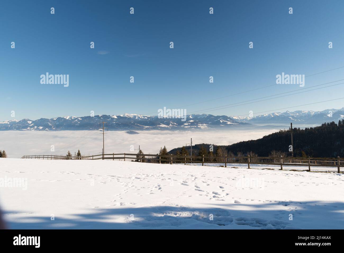 Gais, Appenzell, Switzerland, January 26, 2022 Foggy day over the swiss and austrian rhine valley with the alps in the background Stock Photo