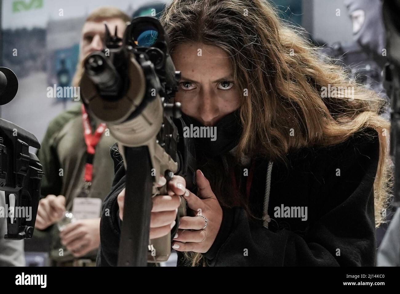 Tel Aviv, Israel. 22nd March, 2022. A woman examines a rifle at ISDEF, Israel's International Security and Defense exhibition, as it opens at EXPO Tel Aviv. The exhibition highlights equipment and technologies for defense, home land security, mega event protection, cybersecurity, intelligence and counter terrorism. ISDEF hosts over 300 exhibiting companies and will be attended by 10,000 visitors and 50 delegations including first time visitors from the Gulf countries and Morocco. Credit: Nir Alon/Alamy Live News Stock Photo