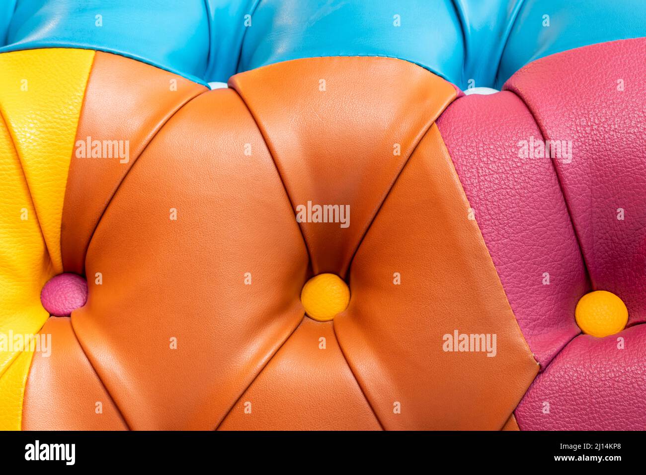 Multicolor leather texture with buttons. Leather upholstery pattern with buttons Stock Photo