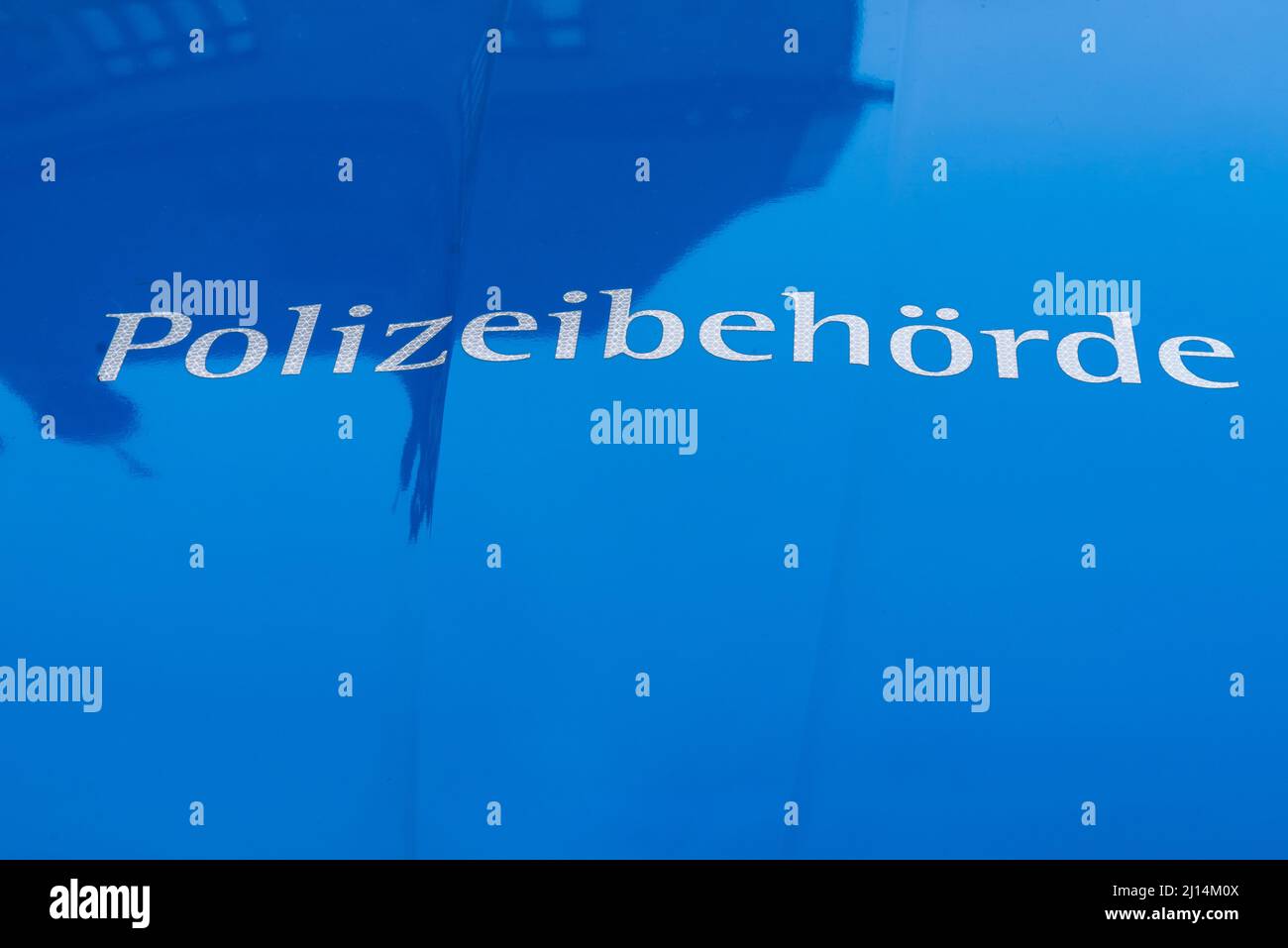 German word Polizeibehörde (police authority) on a police car Stock Photo