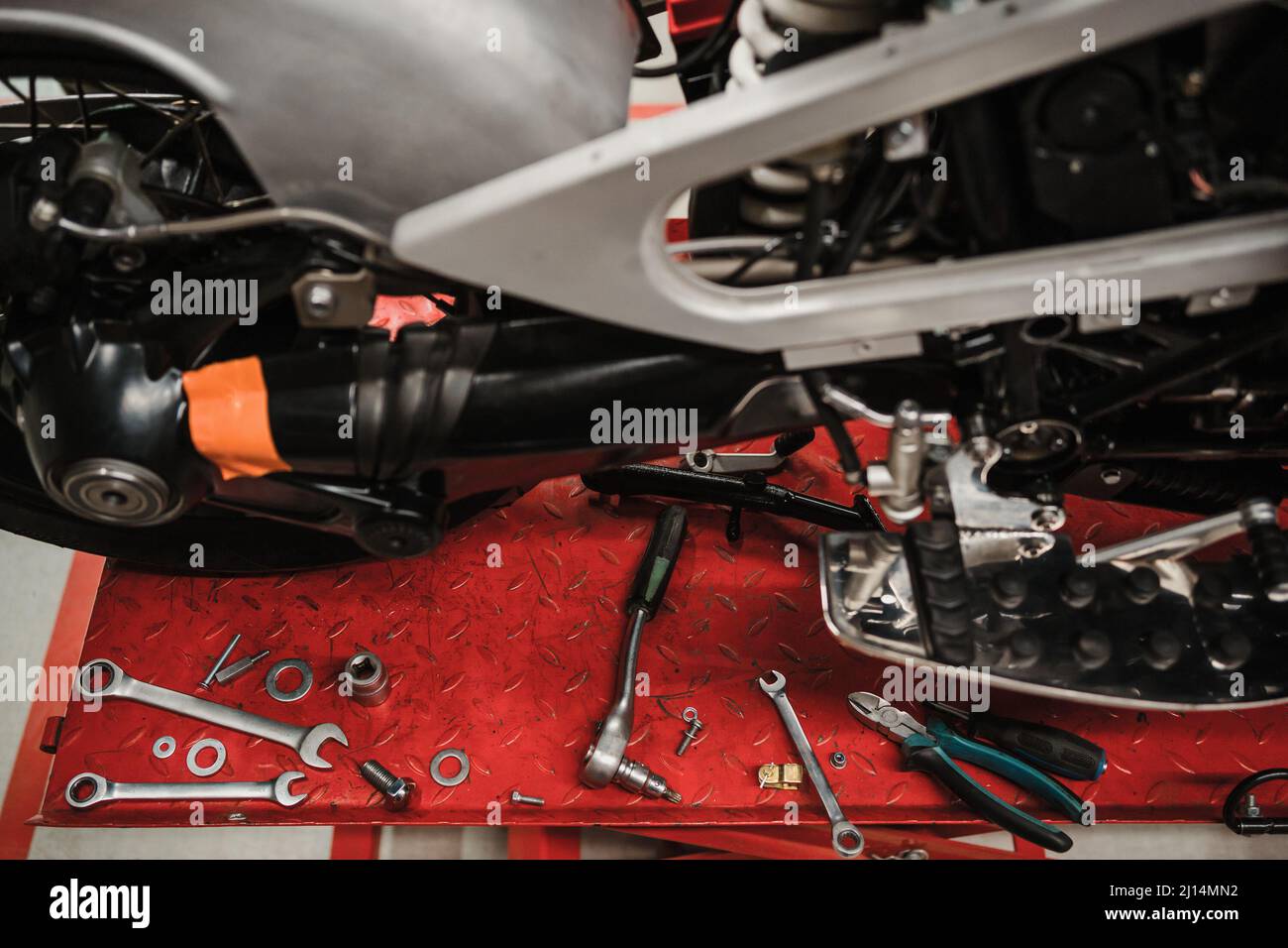 Fixing Custom motorcycle standing in repair shop. Instruments and equipment. Hobbies and unique