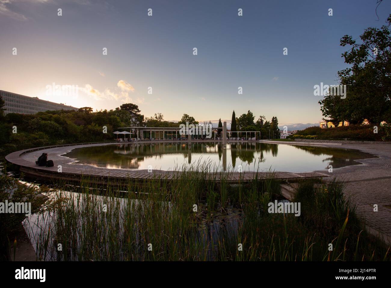 Summer sunset falling onto the Amália Rodrigues Garden and its waterfont café, located in the centre of Lisbon, Portugal. Stock Photo